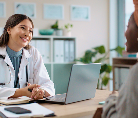 Smiling physician with a laptop